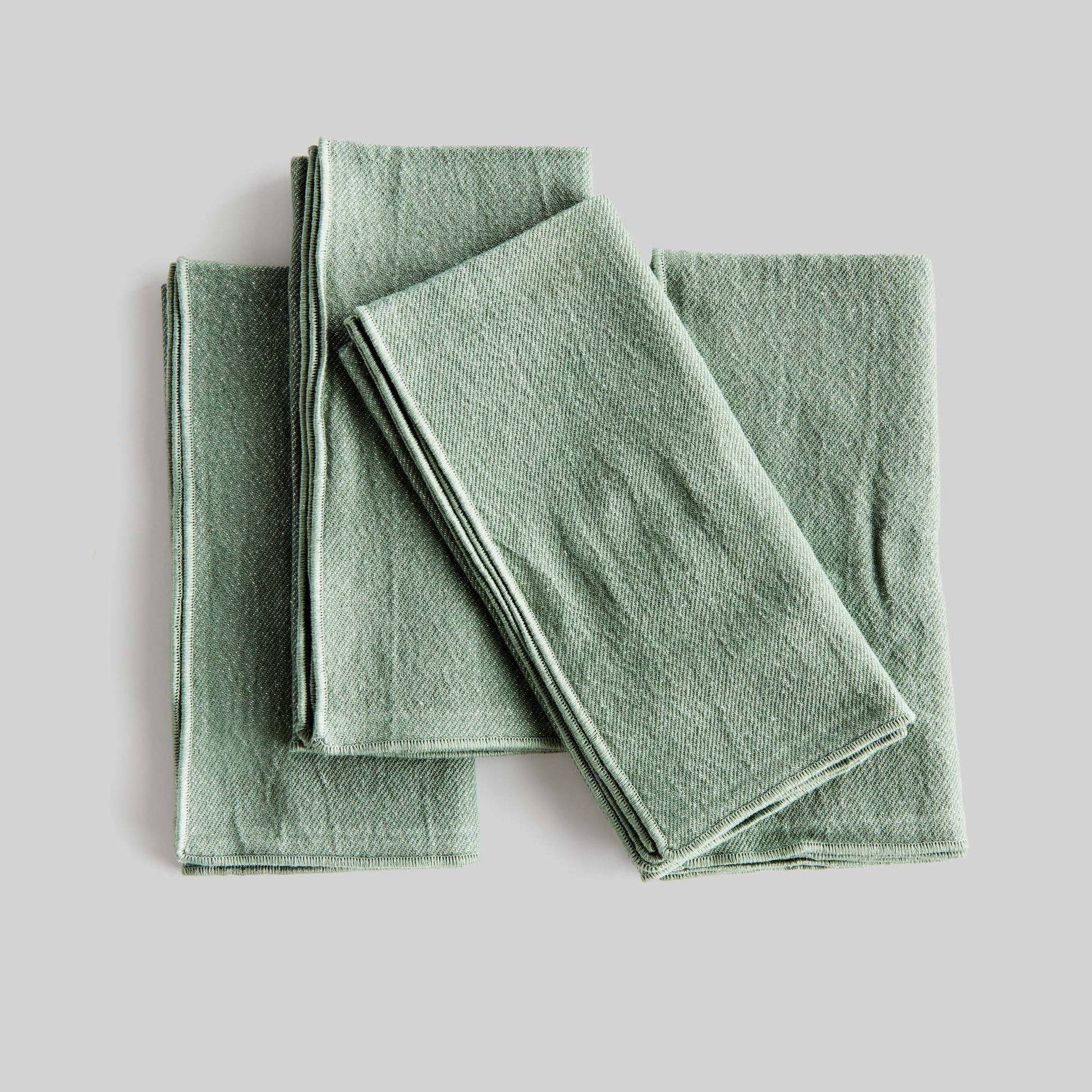 Sage green square cotton dinner napkins set of 4 with gray background.