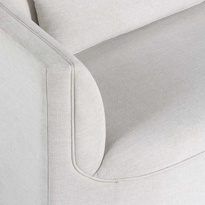Light dove colored fabric sofa on gray background.