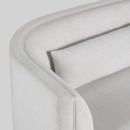 Light dove colored fabric sofa on gray background.