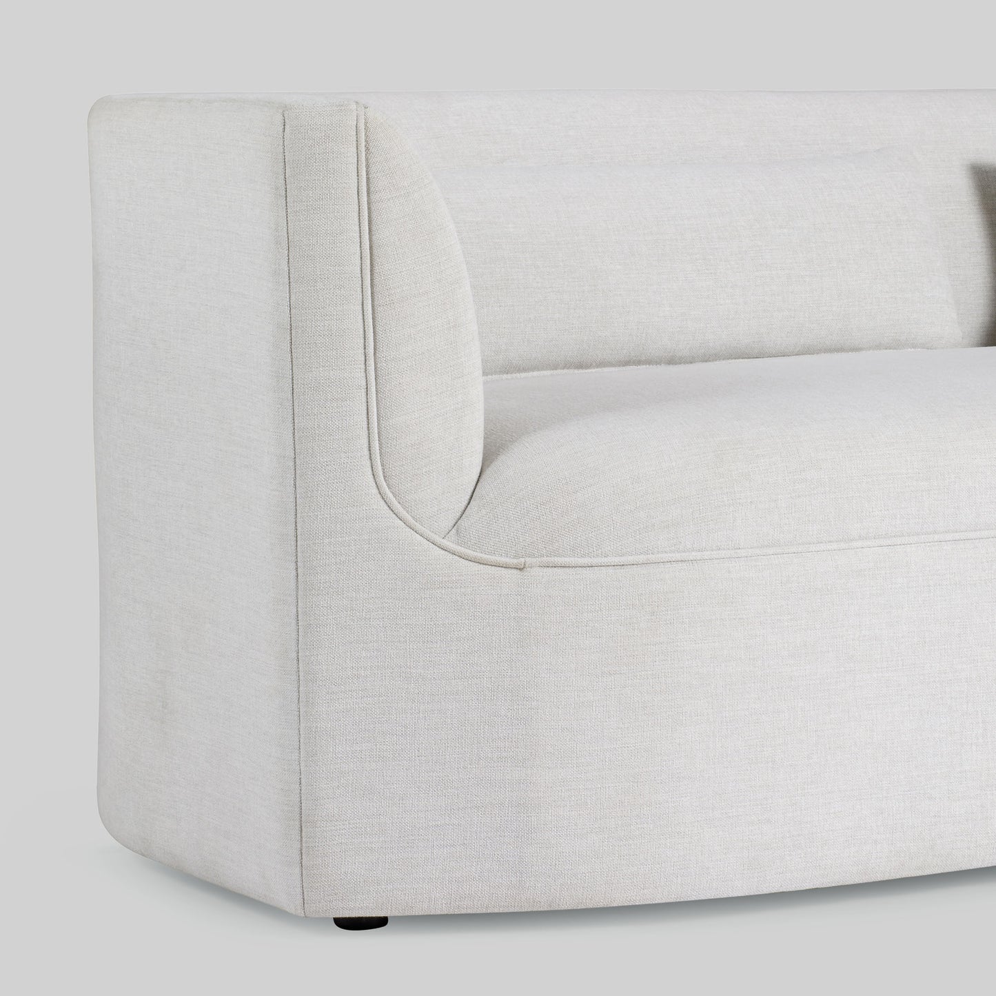 Light dove colored fabric sofa on gray background.