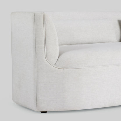 Light dove colored fabric sofa on gray background.