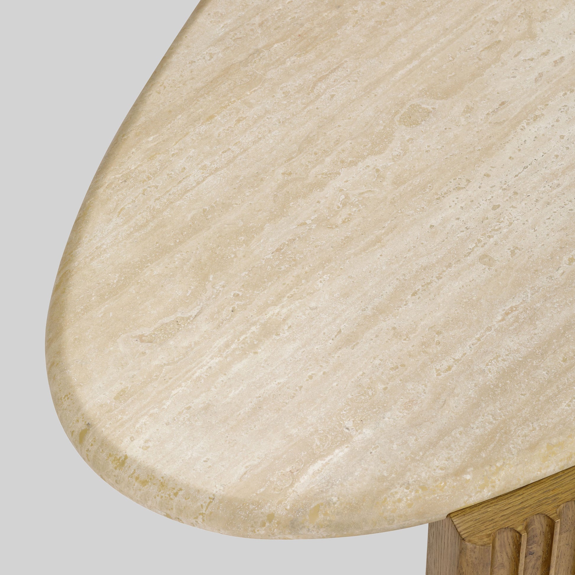 Contemporary light oak coffee table with marble top and wooden fluted base on a gray background.