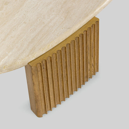 Contemporary light oak coffee table with marble top and wooden fluted base on a gray background.