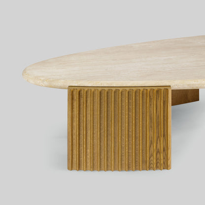 Contemporary light oak coffee table with marble top and wooden fluted base on a gray background.