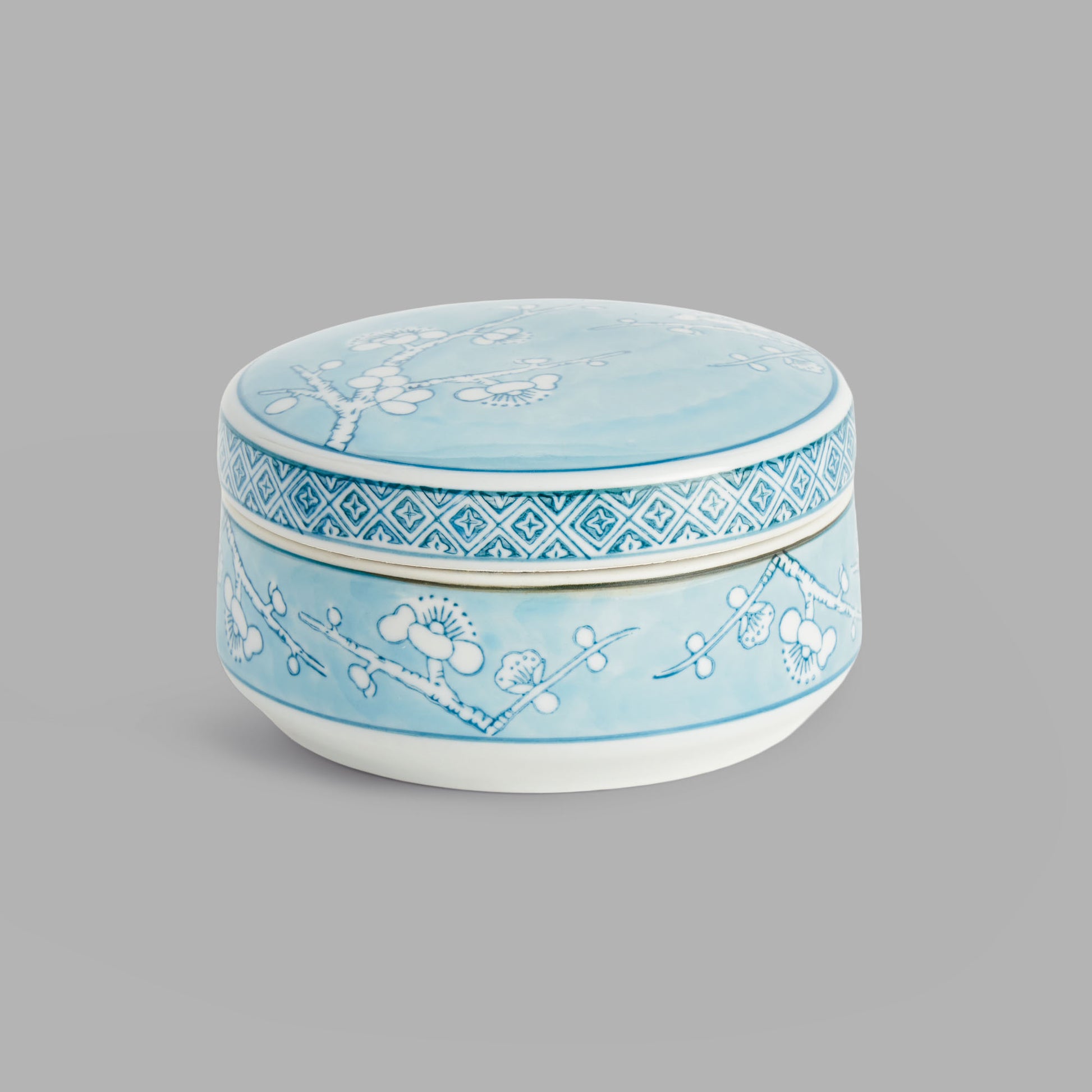 Small round light blue hand-painted porcelain lidded box - stylish home accent (Image1).