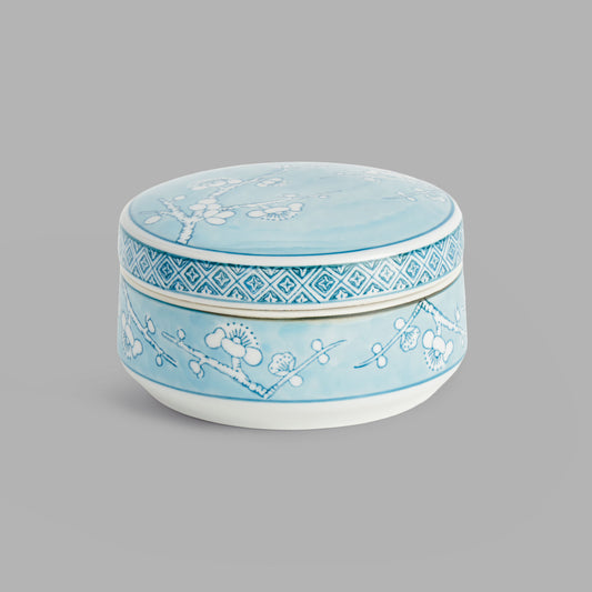 Small round light blue hand-painted porcelain lidded box - stylish home accent (Image1).