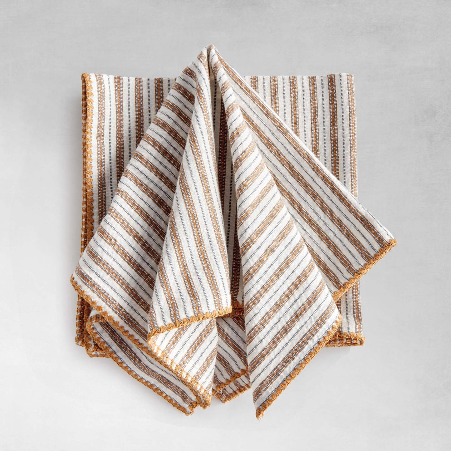 Striped square cotton dinner napkins set of 4, unfolded, with gray background.