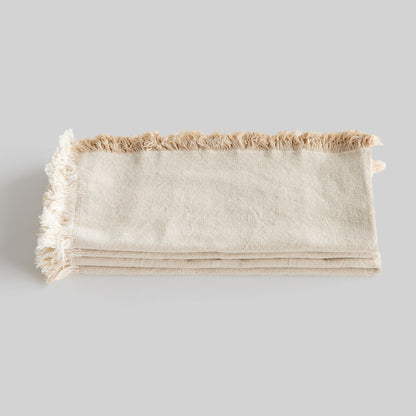 Tan fringe square cotton dinner napkins set of 4, closeup view of stacked napkins.