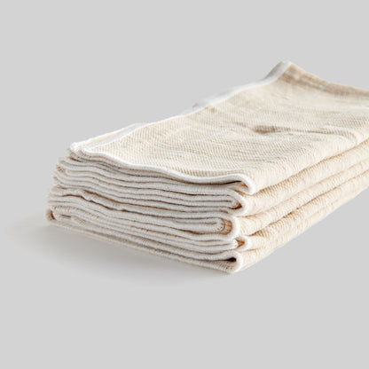 Tan windowpane square cotton dinner napkins set of 4, closeup view of edge detail.