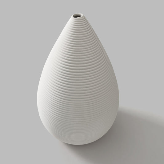 White ceramic vase with ribbed texture on a gray background