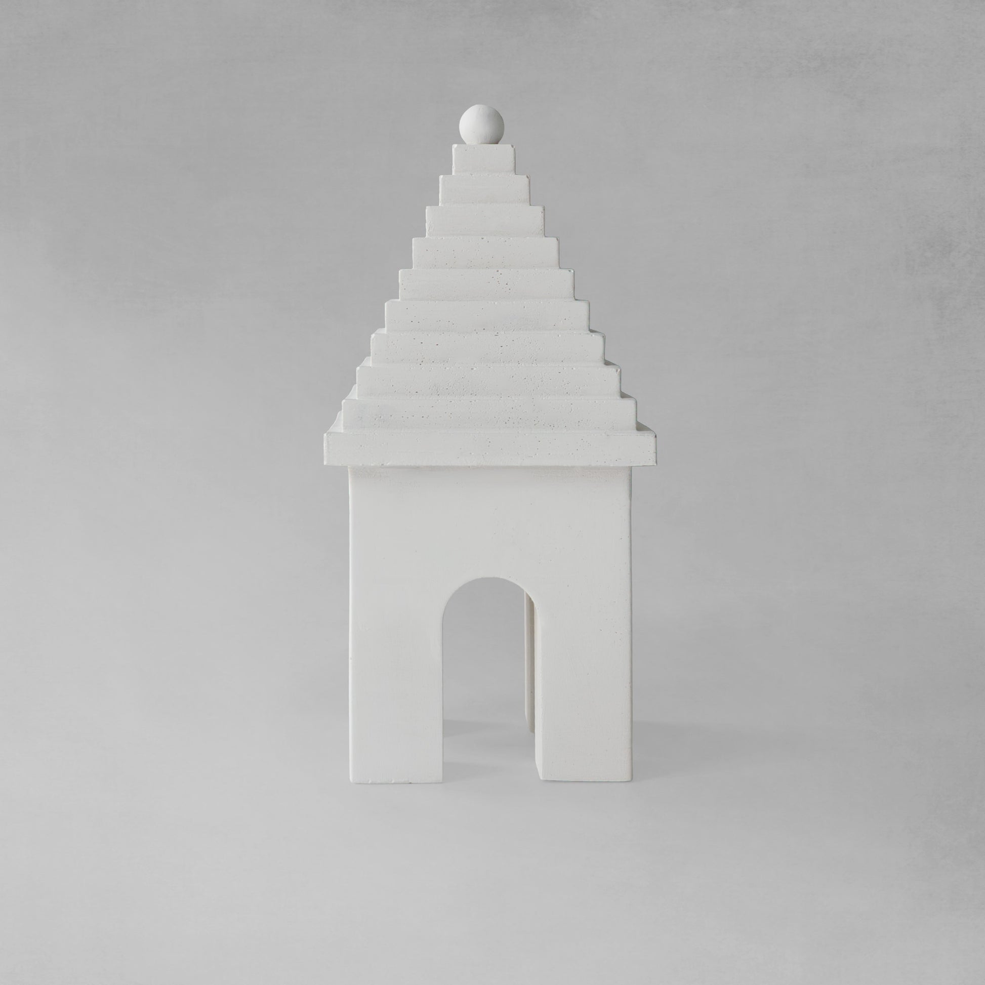Weathered Bermudian buttery decorative object, front view, with gray background.