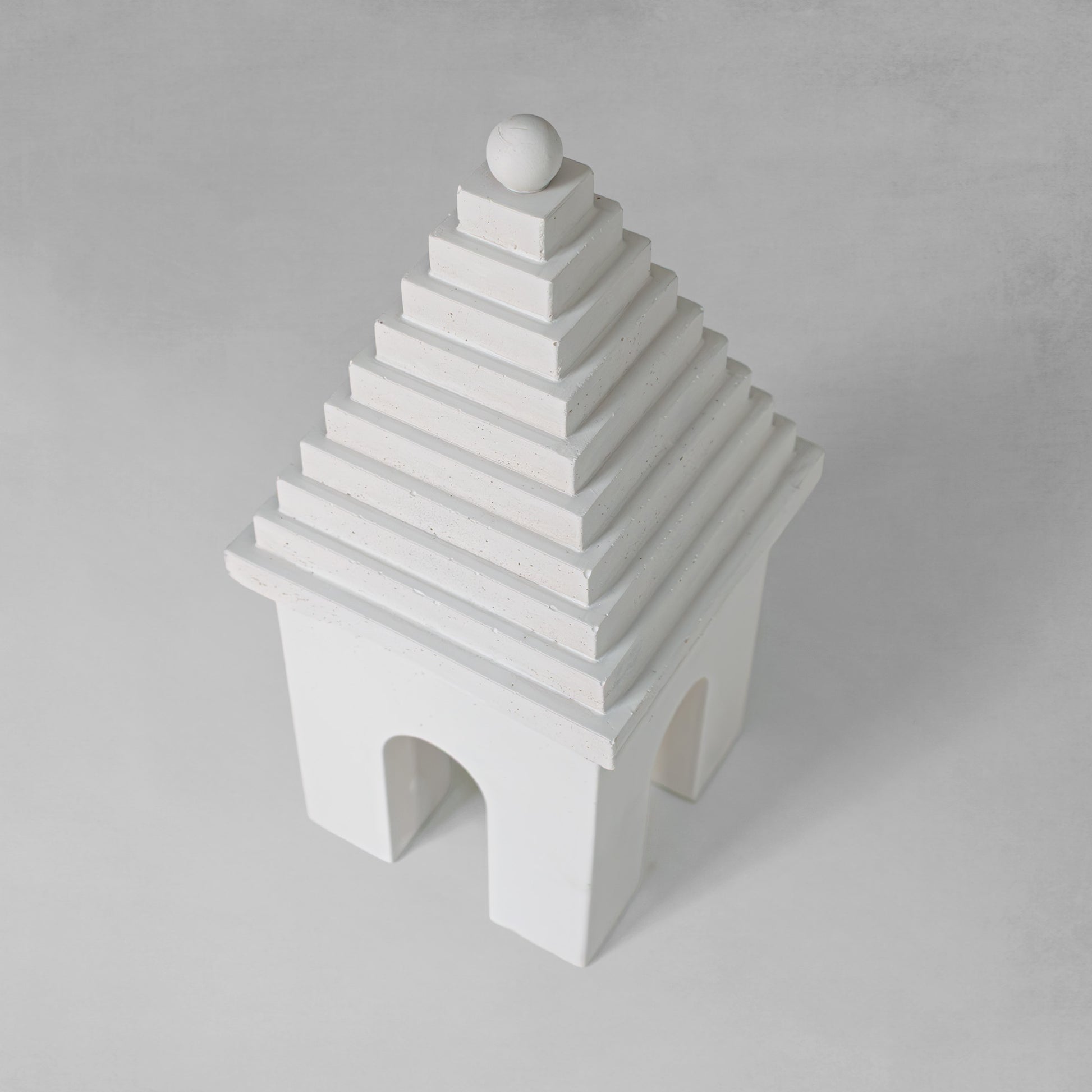 Weathered Bermudian buttery decorative object, top view, with gray background.