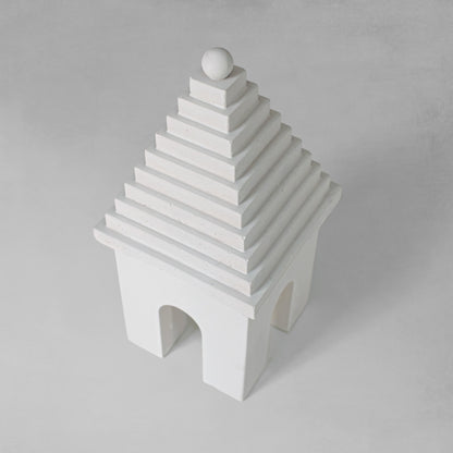 Weathered Bermudian buttery decorative object, top view, with gray background.