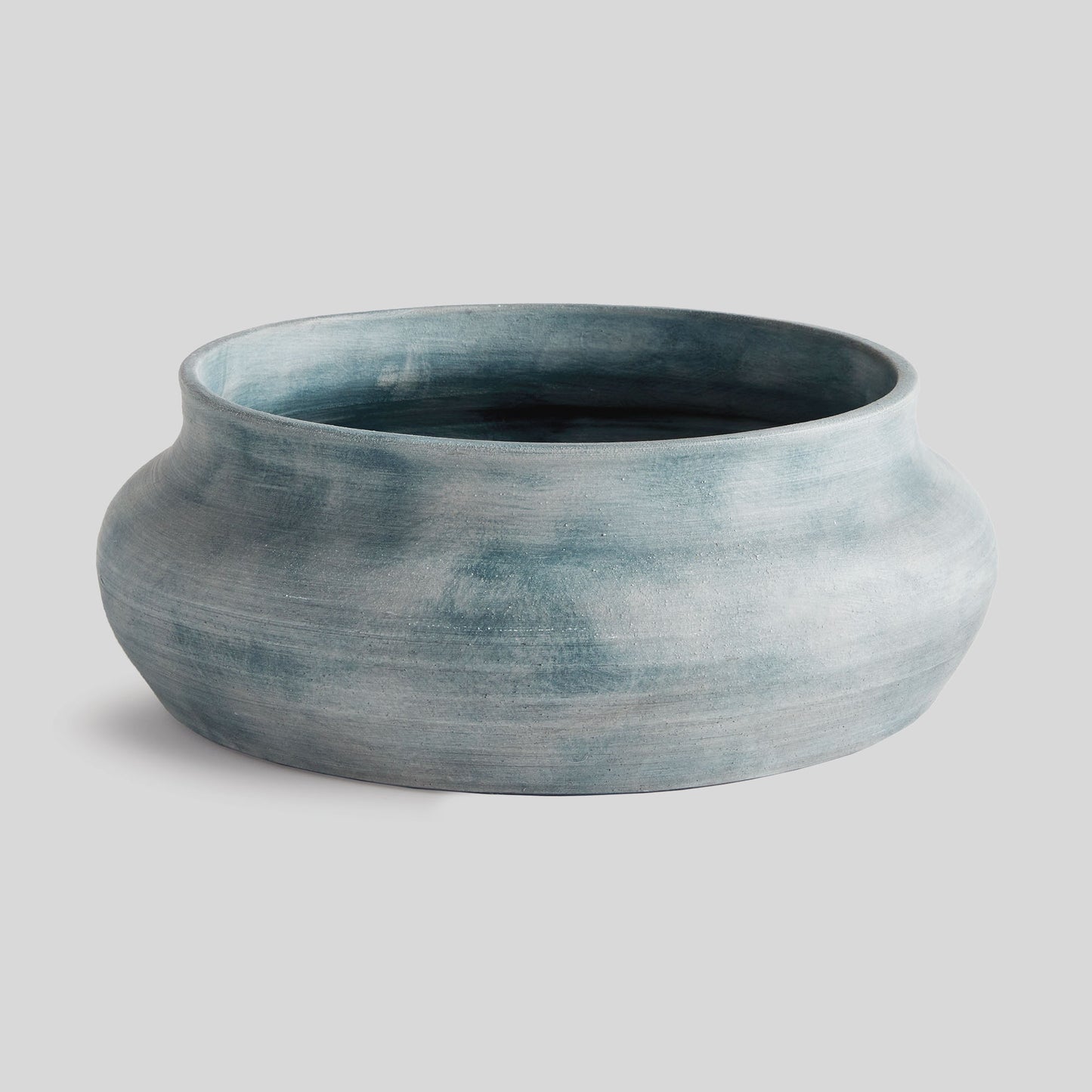 Weathered blue-gray terracotta decorative bowl with gray background.