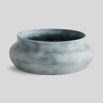 Weathered blue-gray terracotta decorative bowl with gray background.