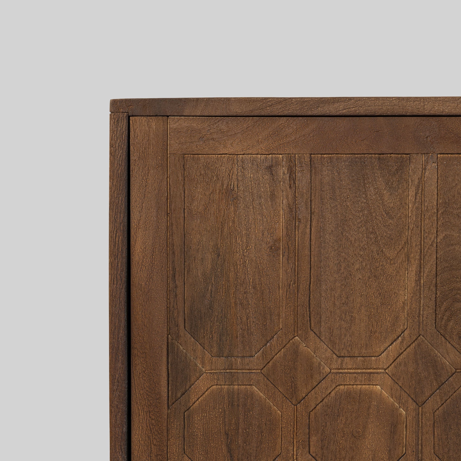 Wood sideboard with geometric pattern on a gray background.