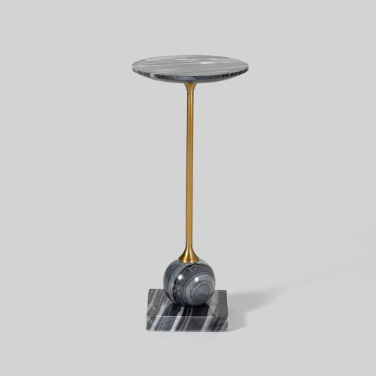 Small round cocktail table with marble top and brass base on a light gray background.