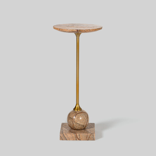 Small round cocktail table with marble top and brass base on a light gray background.