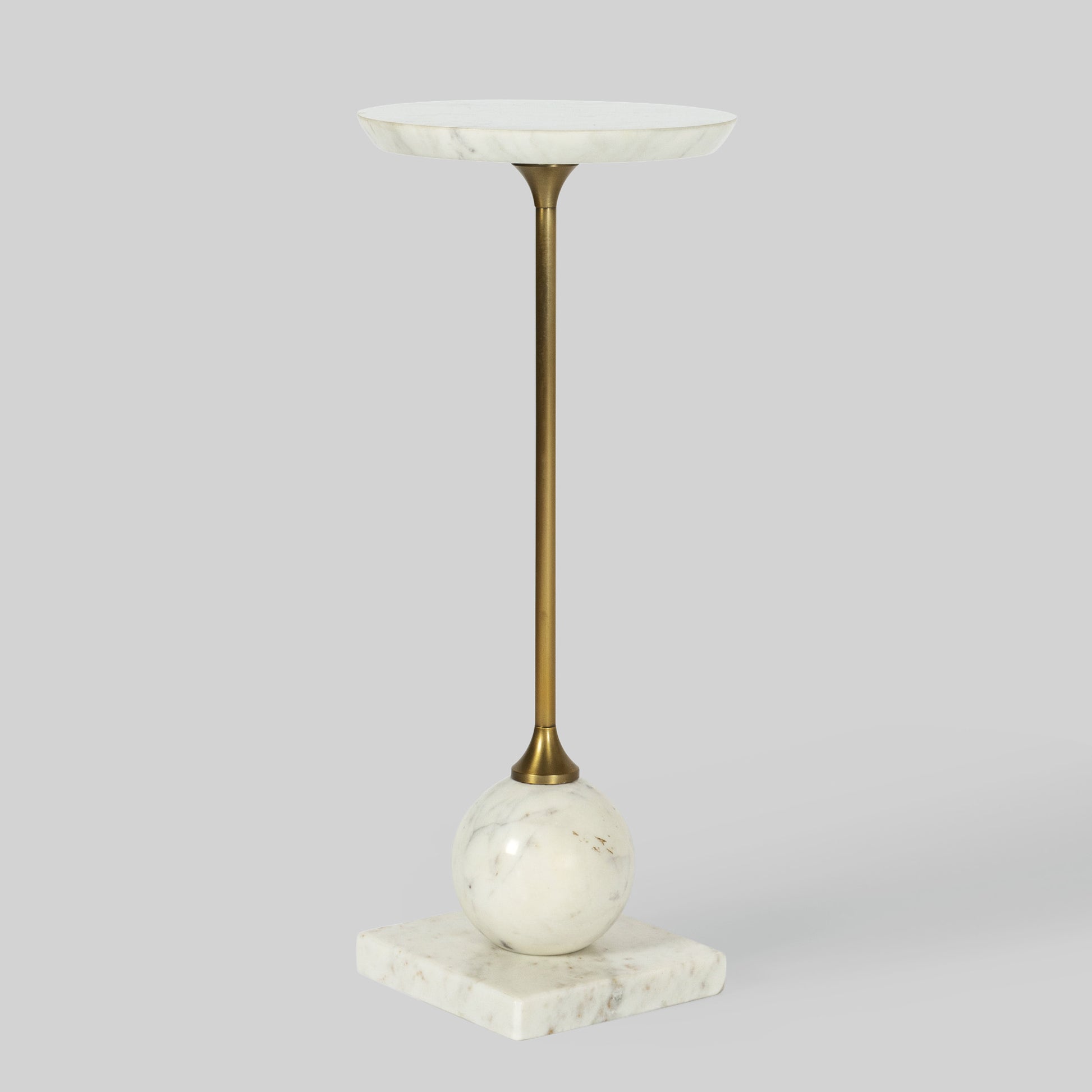 Small round cocktail table with marble top and base on a gray background.