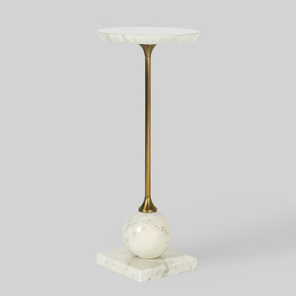 Small round cocktail table with marble top and base on a gray background.