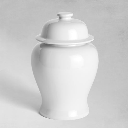 White ceramic lidded ginger jar, small, with gray background.