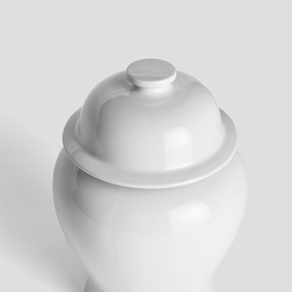 White ceramic lidded ginger jar, small, top view with gray background.
