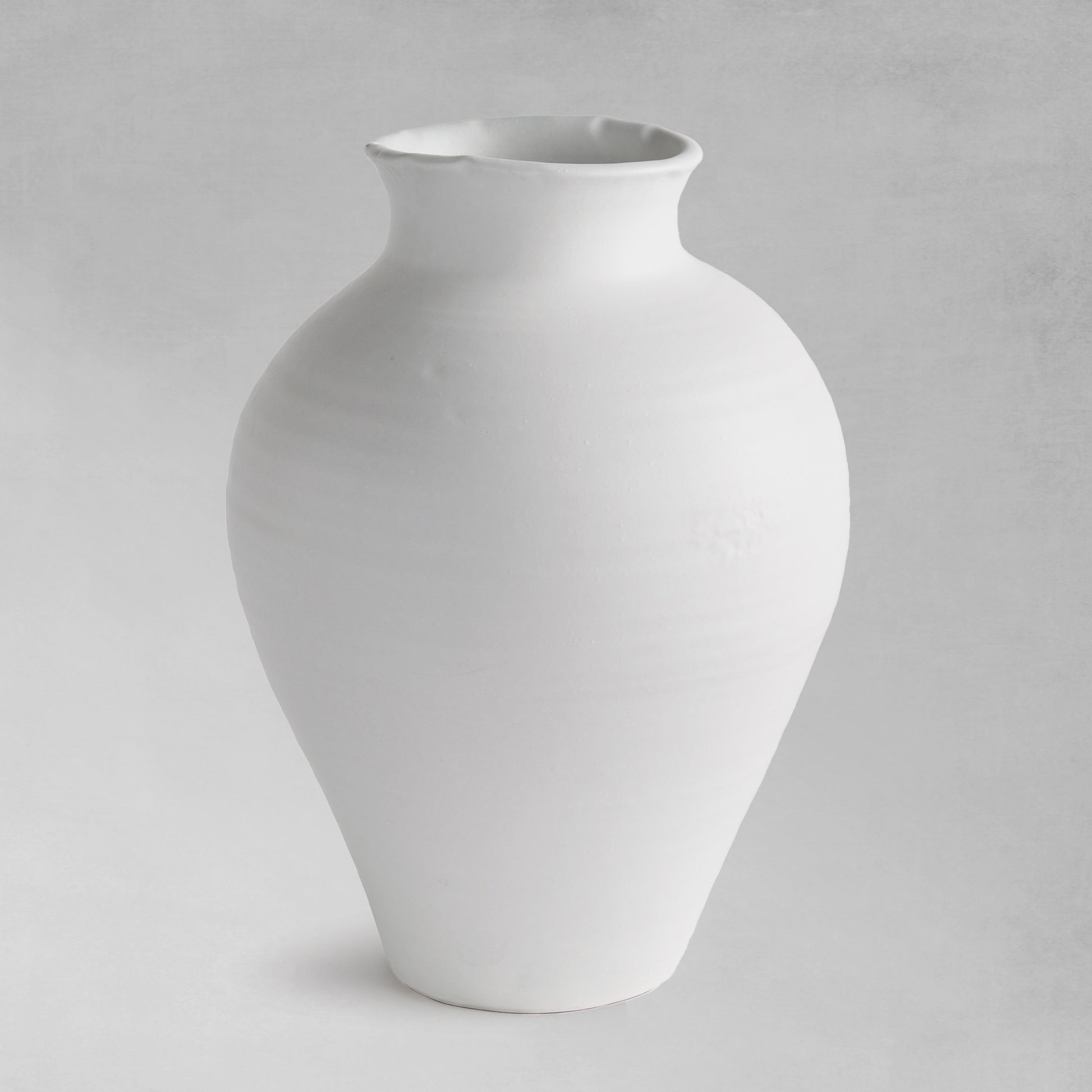 White terracotta wide-mouth vase, large, on a gray background.