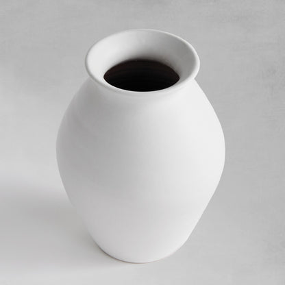 White terracotta wide-mouth vases with a small top opening view.