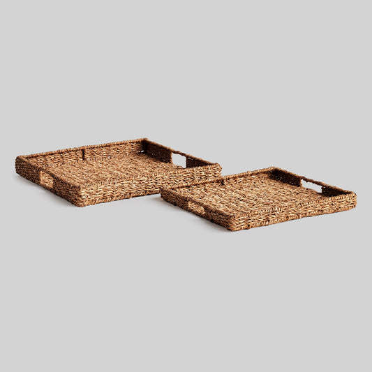 Woven seagrass rectangular tray set with gray background.