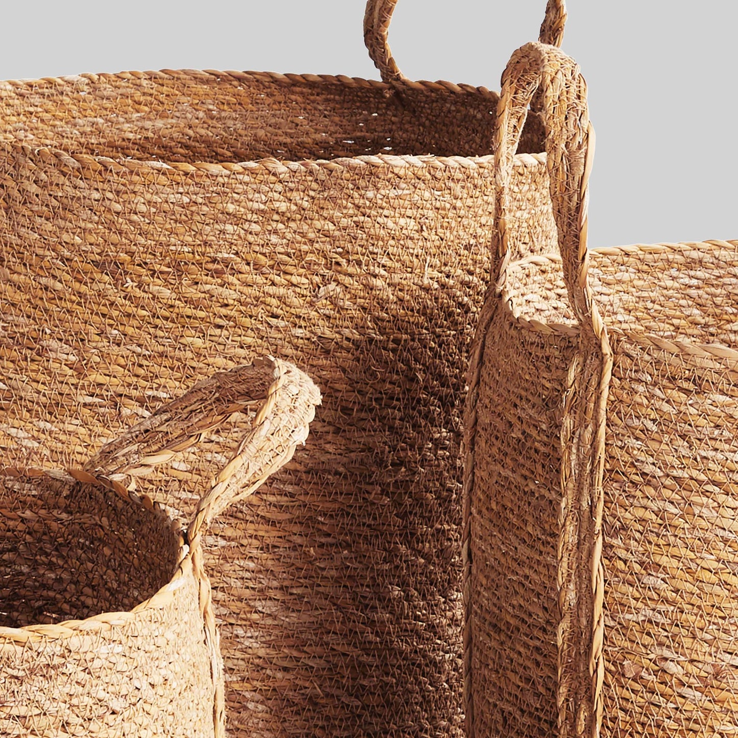 Woven seagrass round baskets, closeup side view.