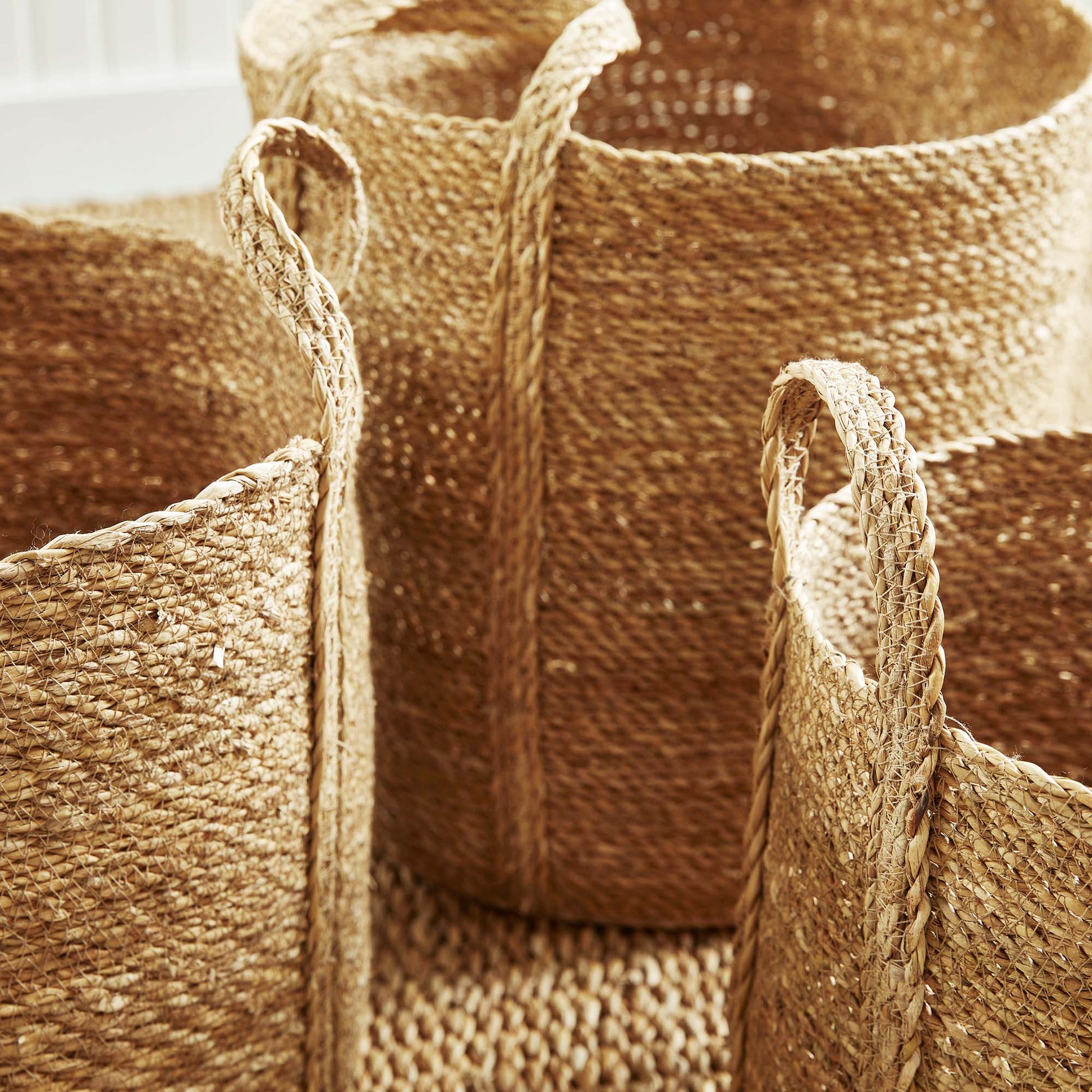 Woven seagrass round baskets, closeup view.